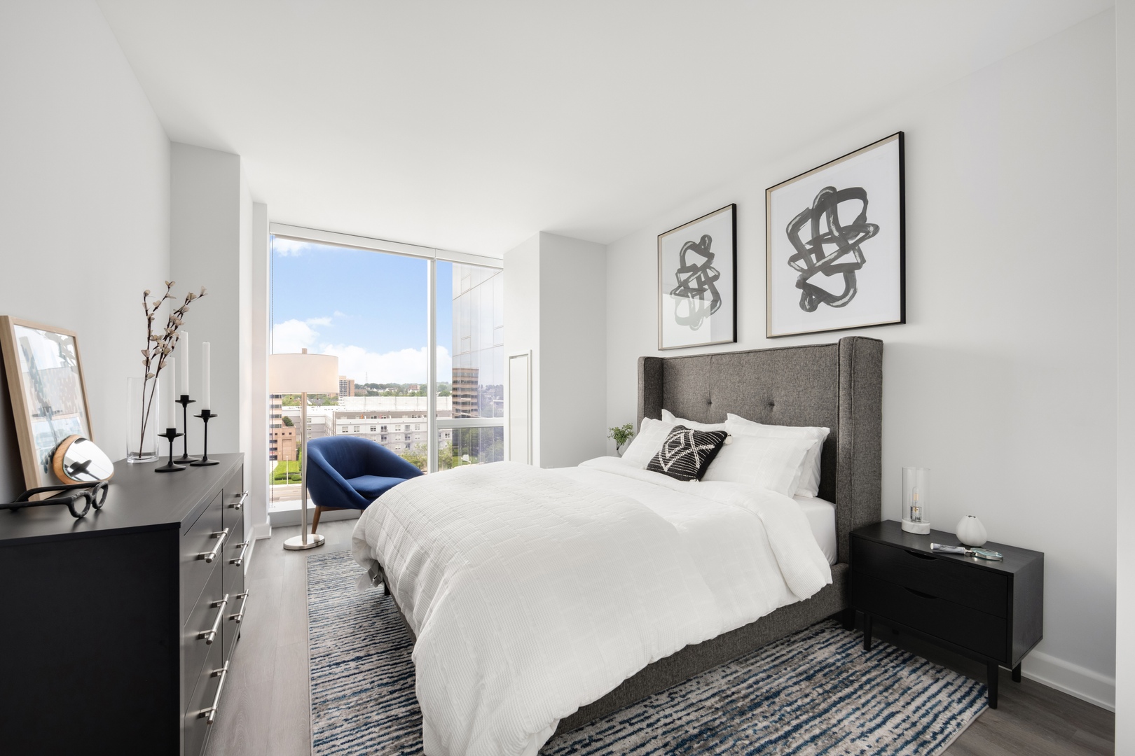 Expansive floor-to-ceiling windows with roller shades and walk-in closets with built-in shelving offer both style and function, enhanced by individually controlled heat and A/C for personalised comfort.