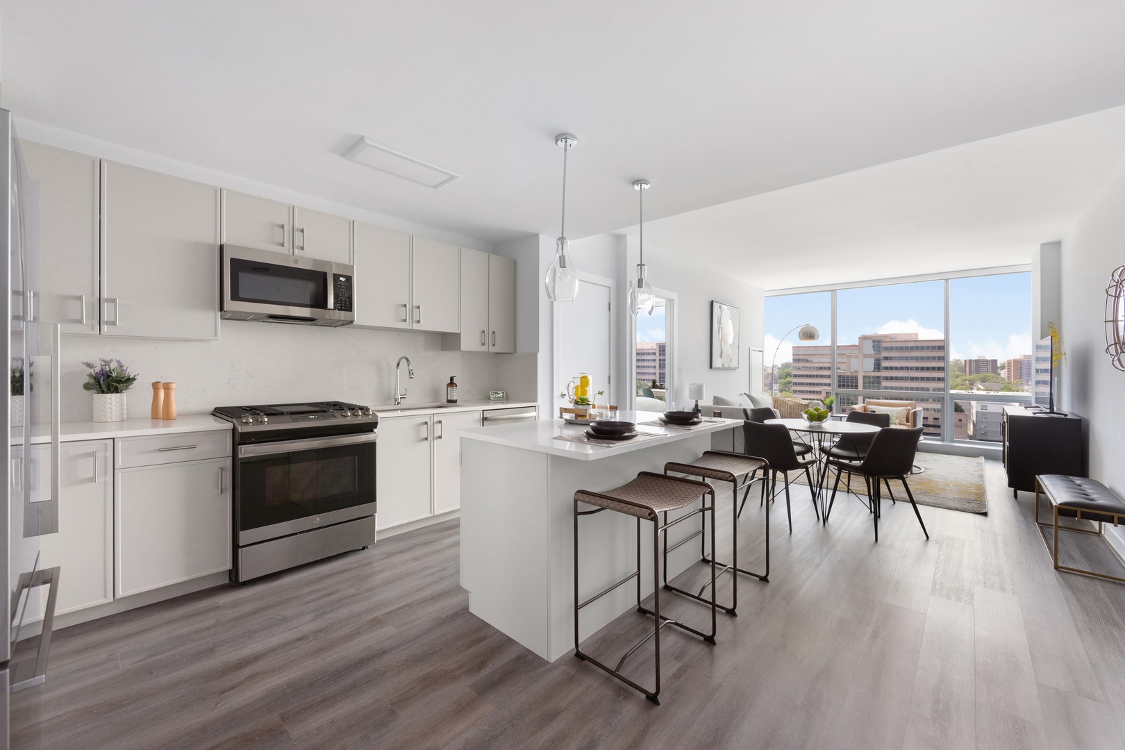 Thoughtfully designed with contemporary Shaker-style cabinetry, Caesarstone countertops, and stainless-steel GE appliances—including a Fisher & Paykel refrigerator—creating a refined, modern culinary experience.