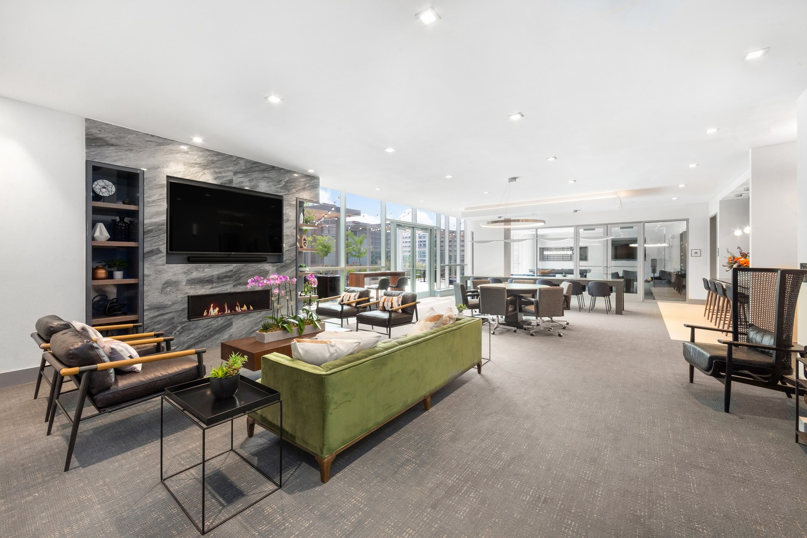 A sophisticated social hub featuring plush seating, warm tones, and a statement fireplace that creates an inviting atmosphere for connection and comfort.